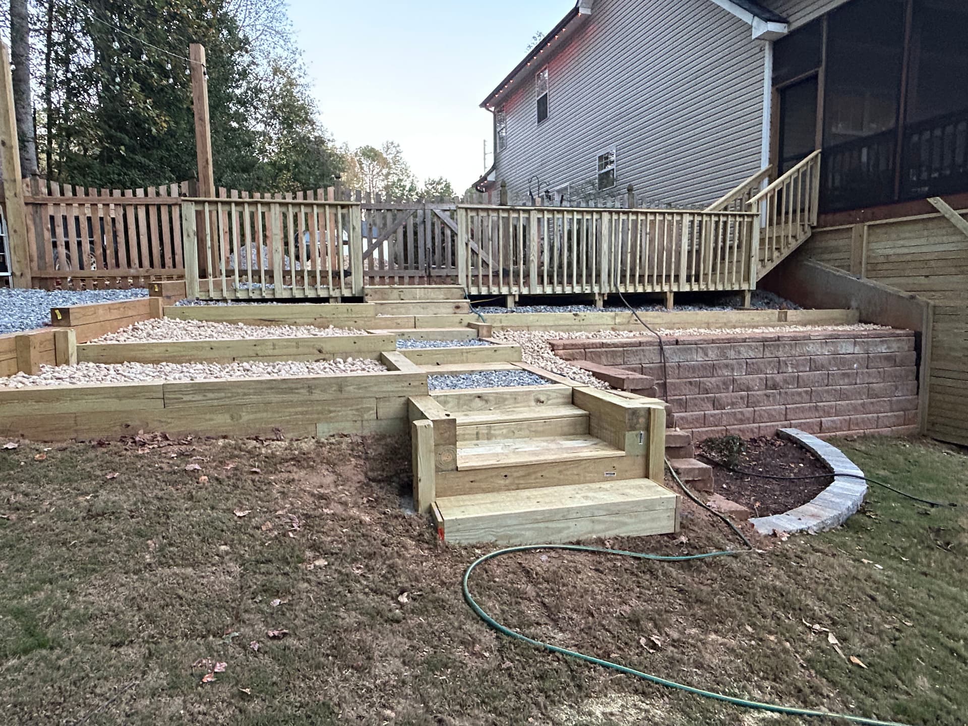 Tiered Garden Masterpiece with Retaining Walls and Wooden Stairs